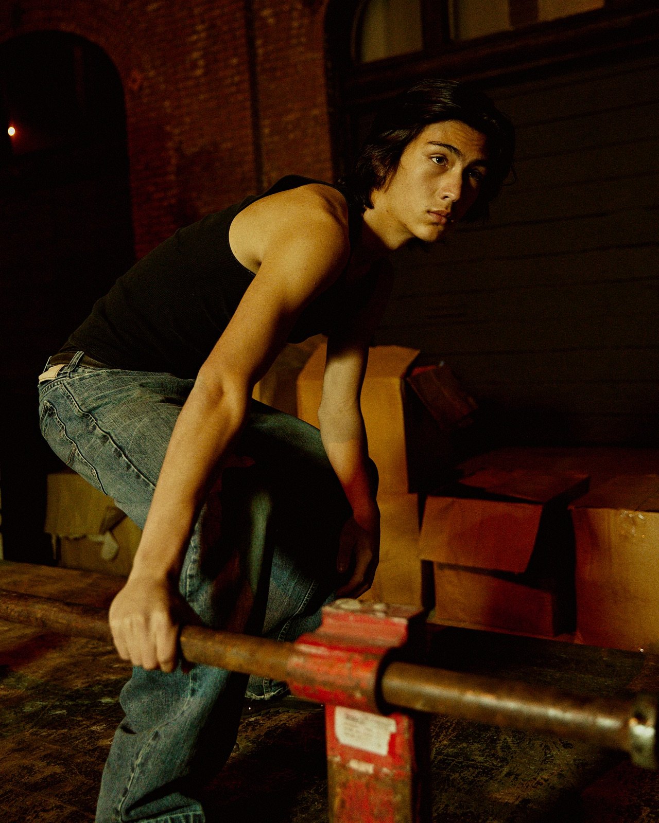 Black tank, leaning on the rail