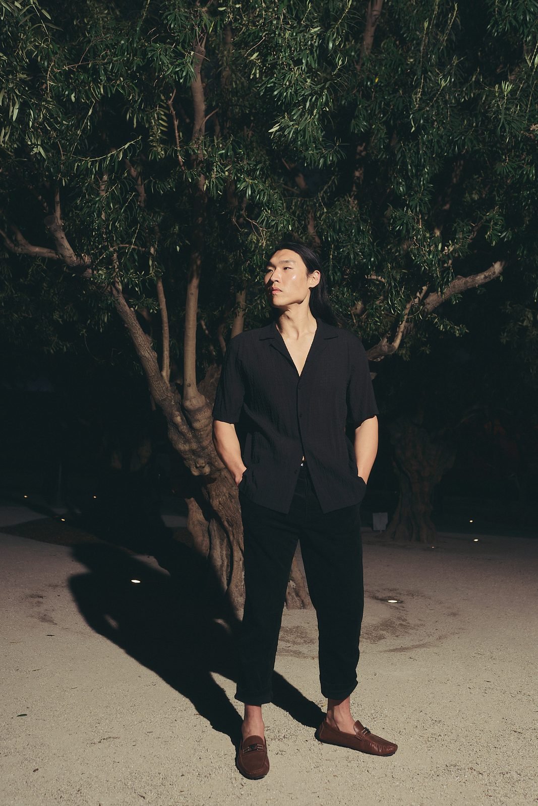 Black shirt, standing at dusk
