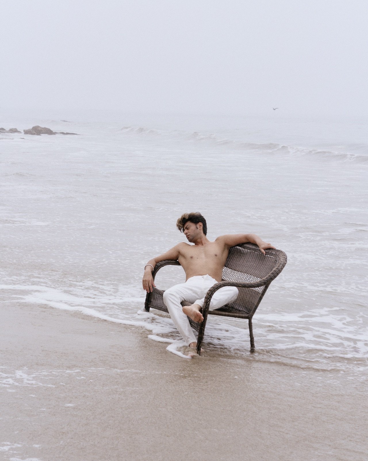 Wicker chair in the surf, fog