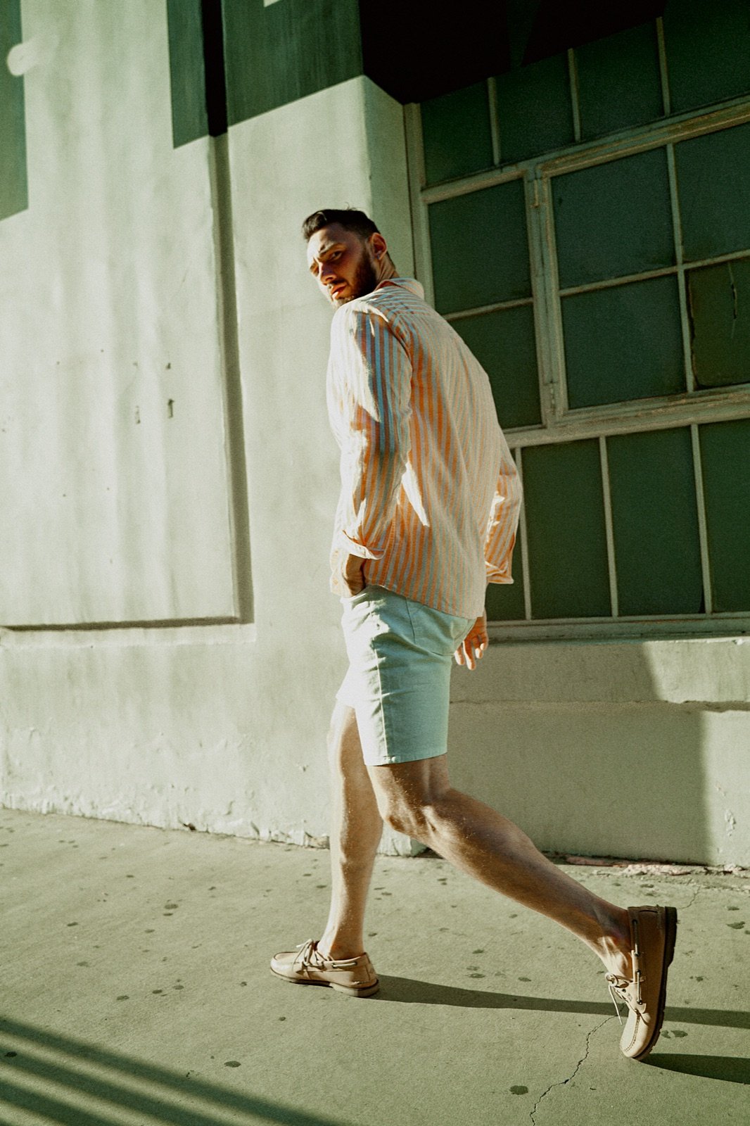 Mint shorts, walking past green windows