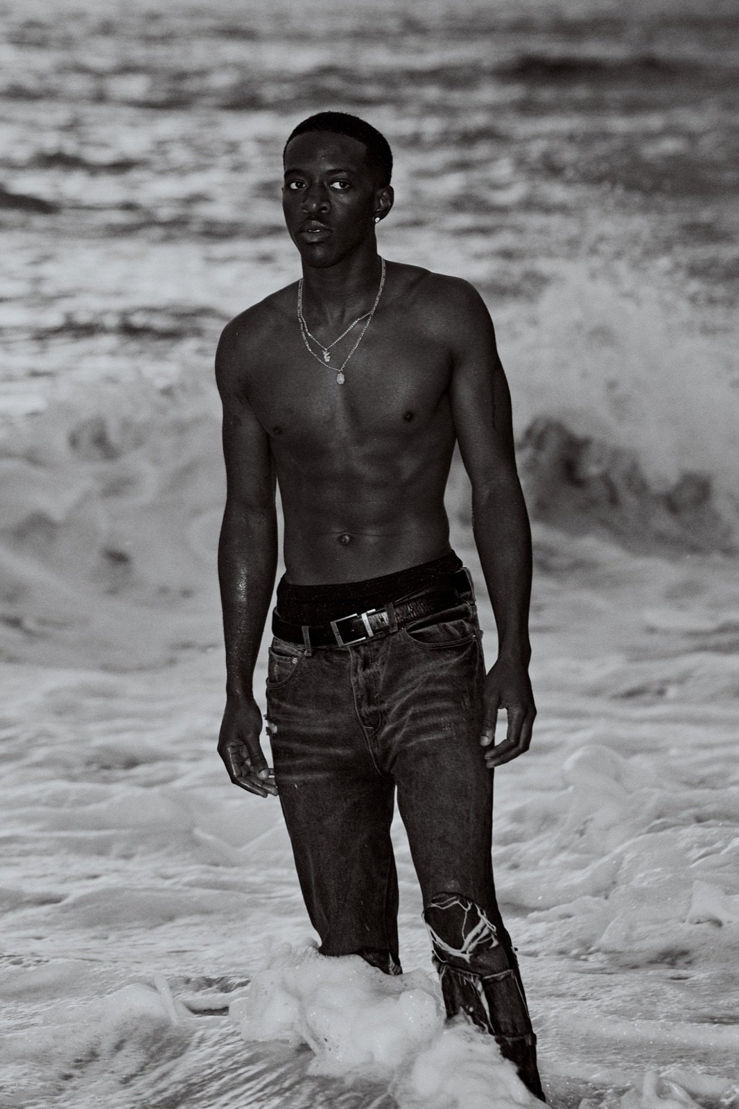 Ripped jeans, standing in the waves