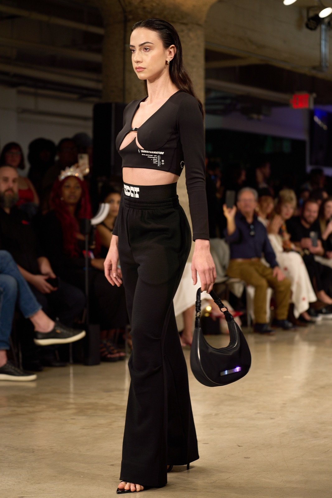 Black crop top, wide trousers and a bag